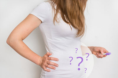 A woman stands against a blank background. This reflects concepts of infertility counseling in San Diego, CA with Headway Therapy.